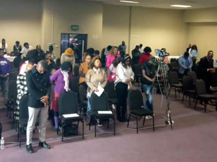 A congregation standing and worshipping together at a previous Glorious Worship gathering.
